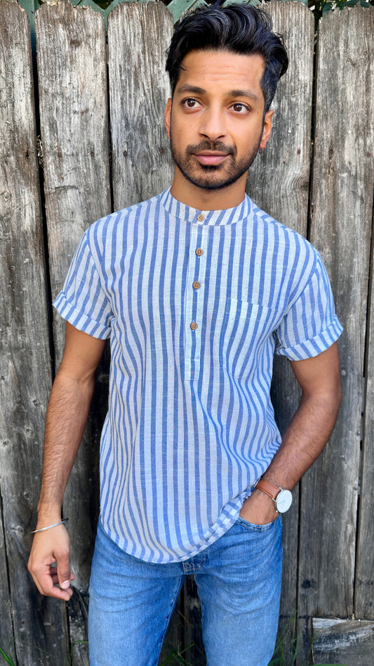 Band Collar Men's Shirts Quarter Button Stripes Cotton. Showcasing the signature South Asian Band Collar neck coupled with coconut button enclosures; The Kurta effortlessly blends Eastern aesthetics with Western style. Quarter button, blue & white stripes. A shirt designed to be a South Asian inspired elevated casual cotton shirt.