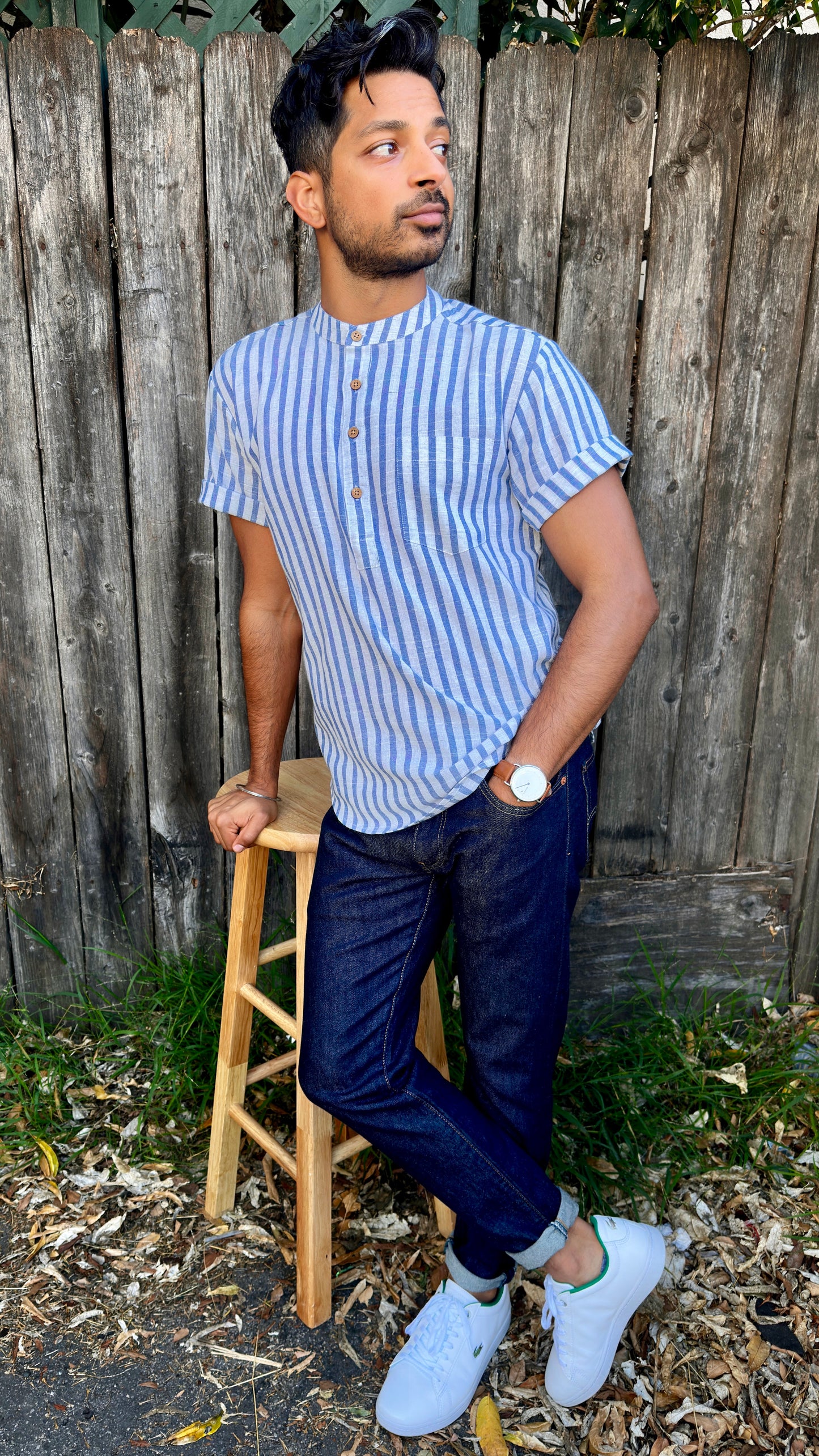 Band Collar Men's Shirts Quarter Button Stripes Cotton. Showcasing the signature South Asian Band Collar neck coupled with coconut button enclosures; The Kurta effortlessly blends Eastern aesthetics with Western style. Quarter button, blue & white stripes. A shirt designed to be a South Asian inspired elevated casual cotton shirt.