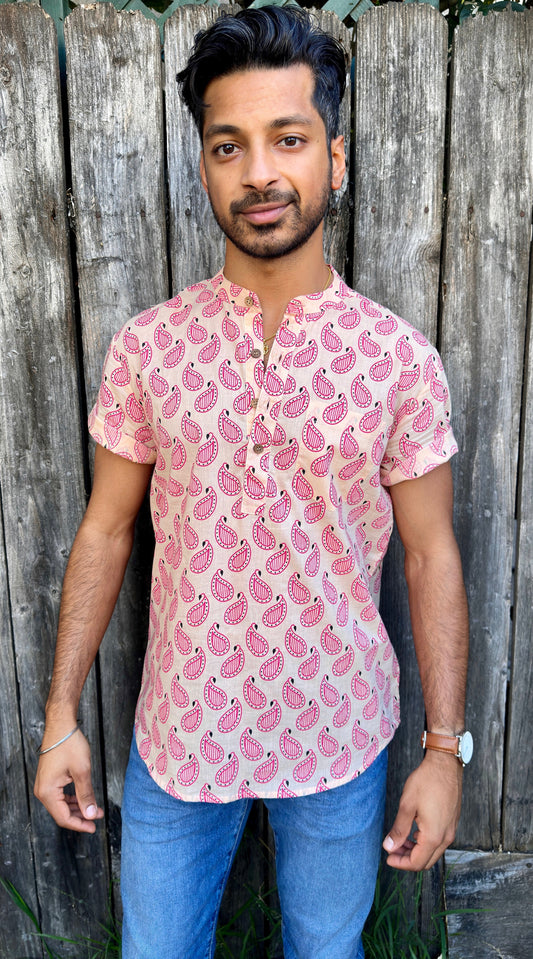 Paisley | Kurta | Band Collar Men's Shirts Quarter Button Cotton. Showcasing the signature South Asian Band Collar neck coupled with coconut button enclosures; The Kurta effortlessly blends Eastern aesthetics with Western style. Quarter button, pink paisley print. A shirt designed to be a South Asian inspired elevated casual cotton shirt. 