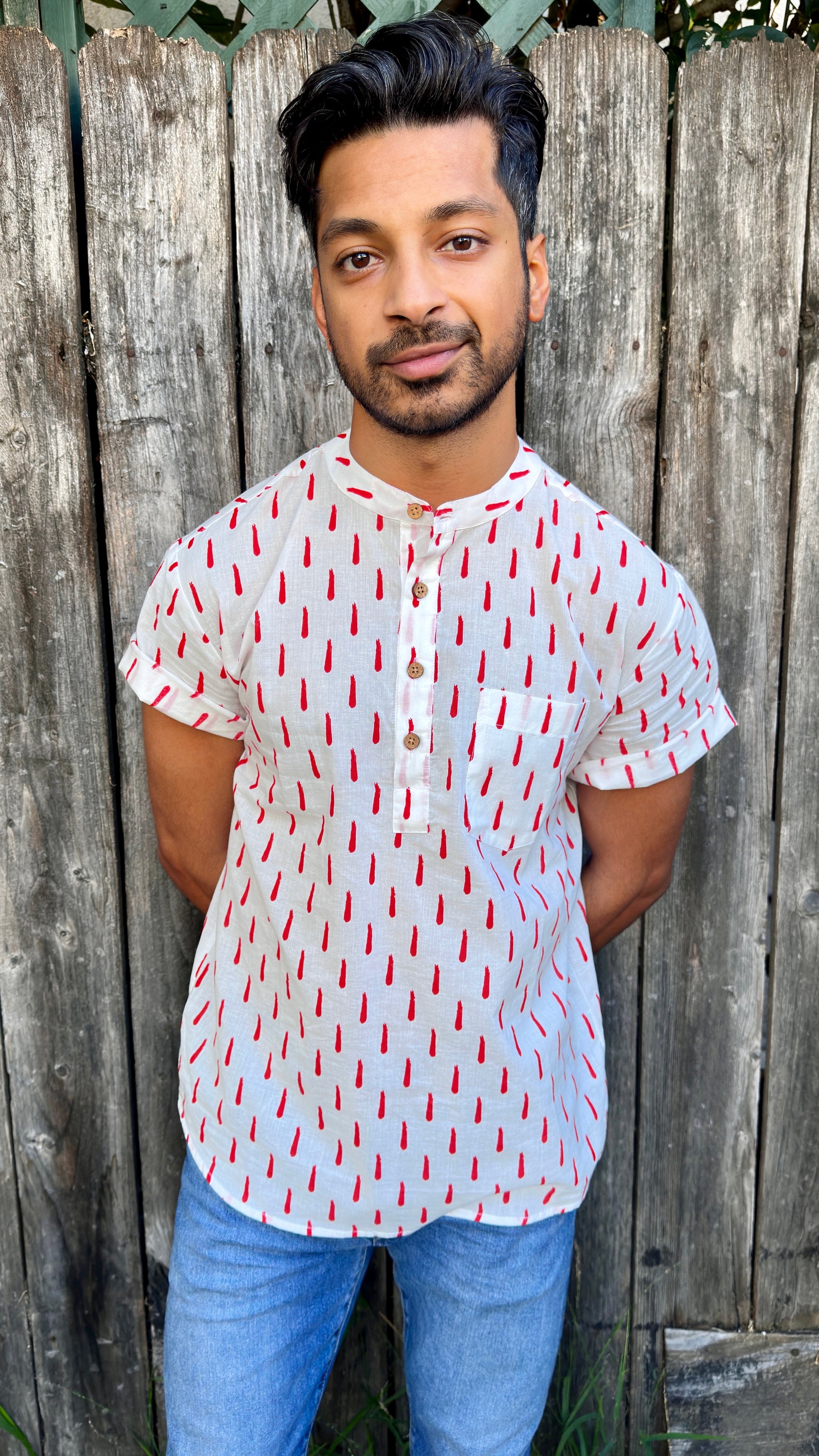 Showcasing the signature South Asian Band Collar neck coupled with coconut button enclosures; The Kurta effortlessly blends Eastern aesthetics with Western style. Quarter button, red swoosh print. A shirt designed to be a South Asian inspired elevated casual cotton shirt. Tilak | Kurta | Band Collar Men's Shirts Quarter Button Cotton. 